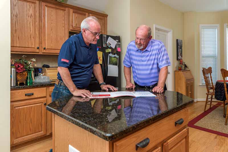 dealer and customer at kitchen counter